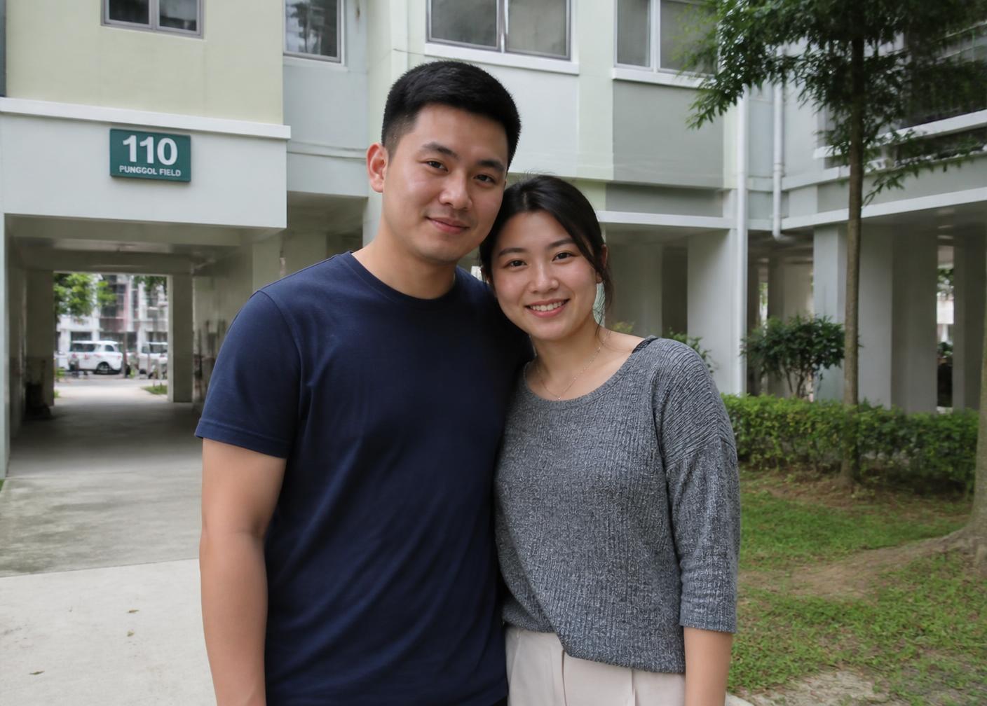 A young Singaporean couple outside an HDB block