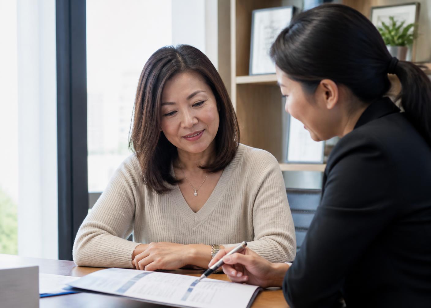 A woman reviewing documents with a specialist